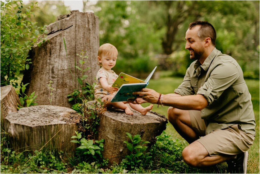 dad reading a book to a baby girl