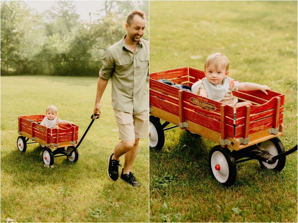 little girl with dad pulling her in a wagon