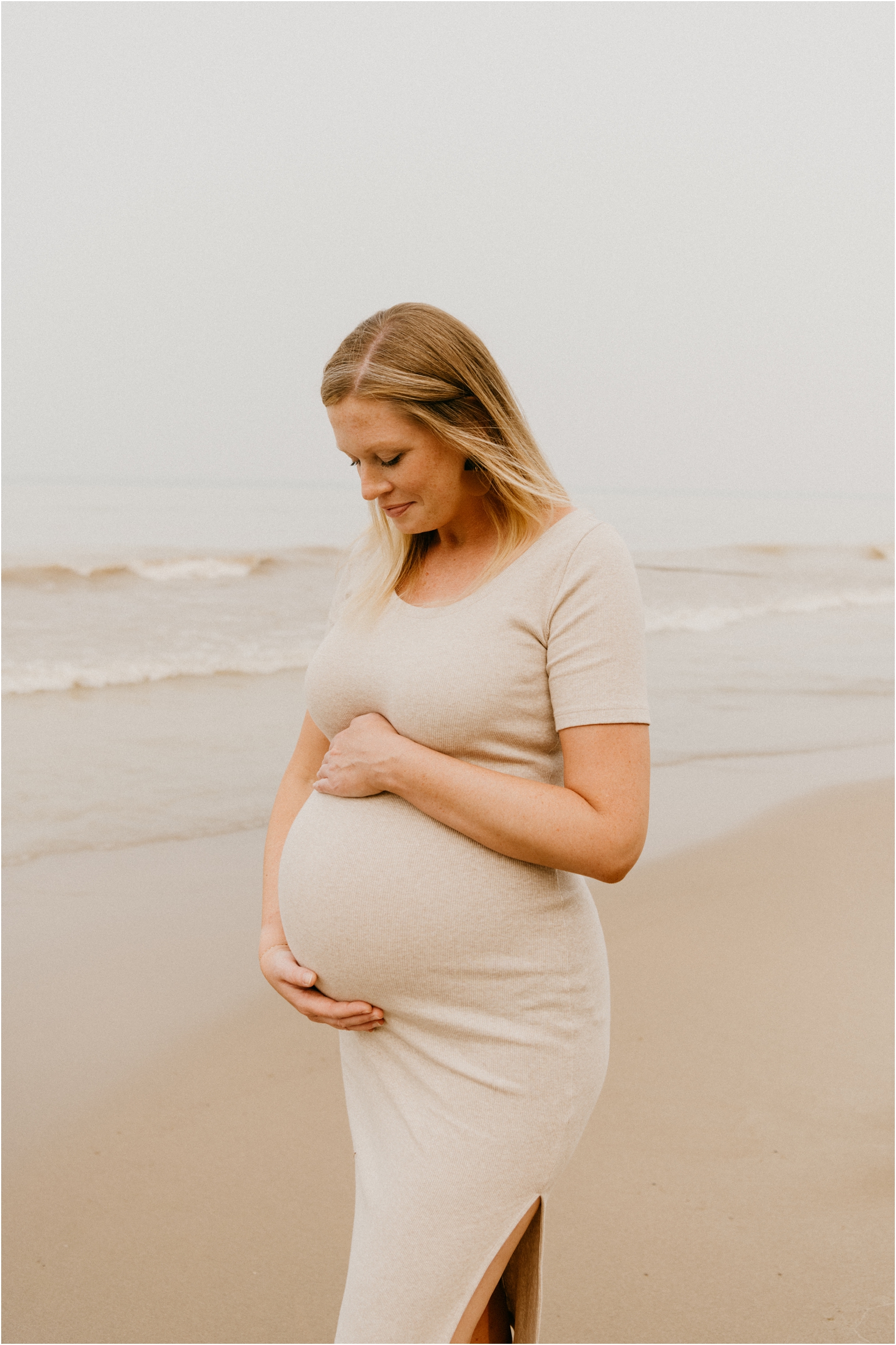 smiling posing pregnant woman by lake Michigan