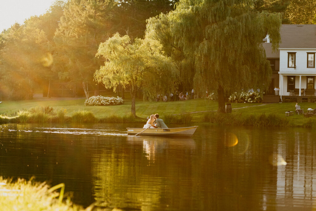 bride and groom at golden hour in row boat