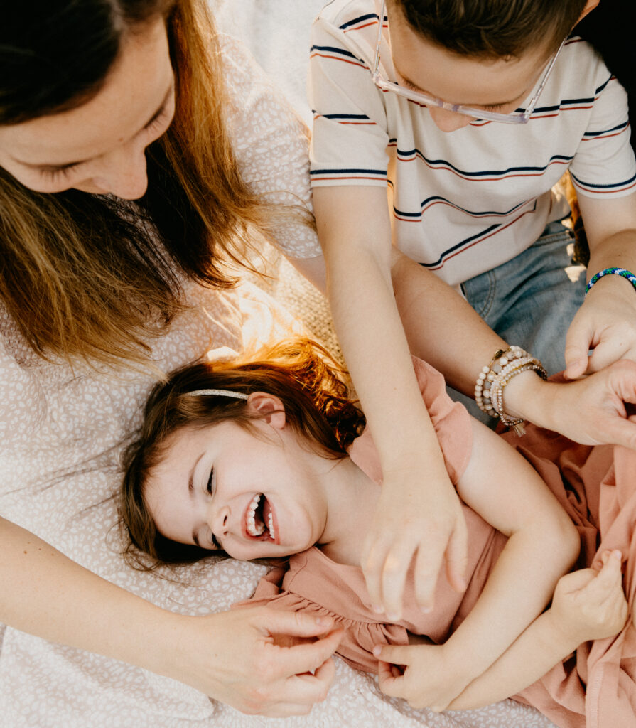 family photo with daughter getting tickled