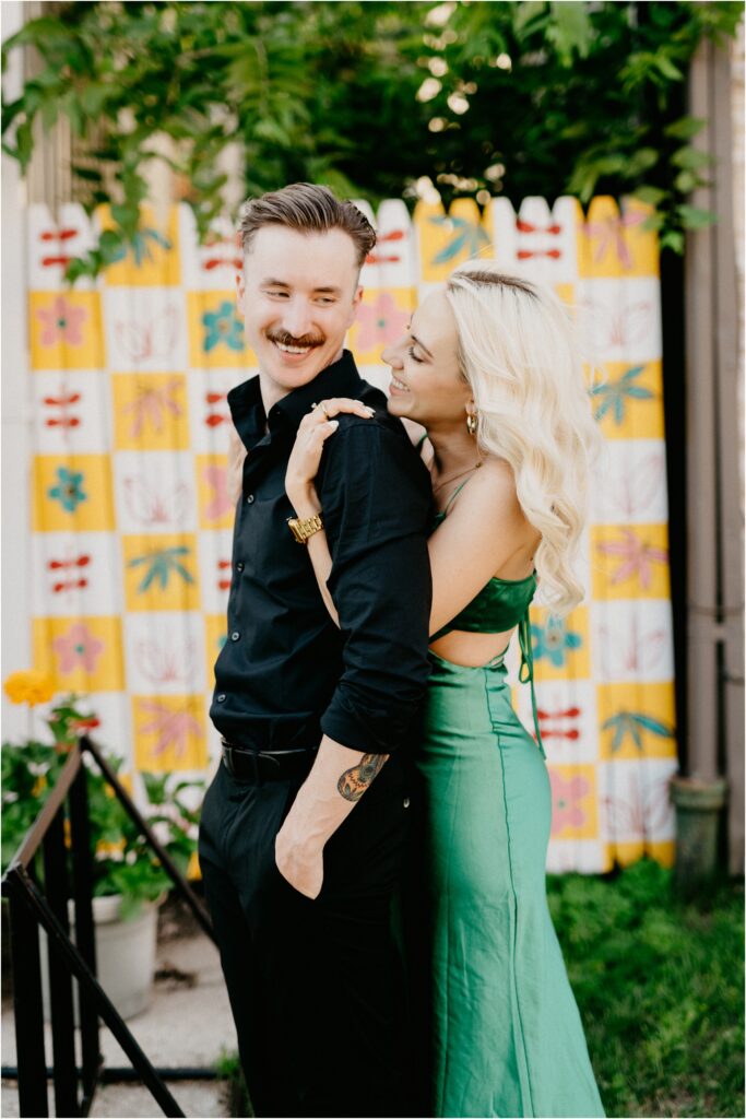 engagement photo of a couple with a woman in a green dress