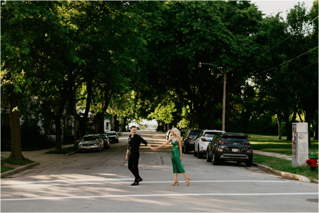 couple walking across the street holding hands