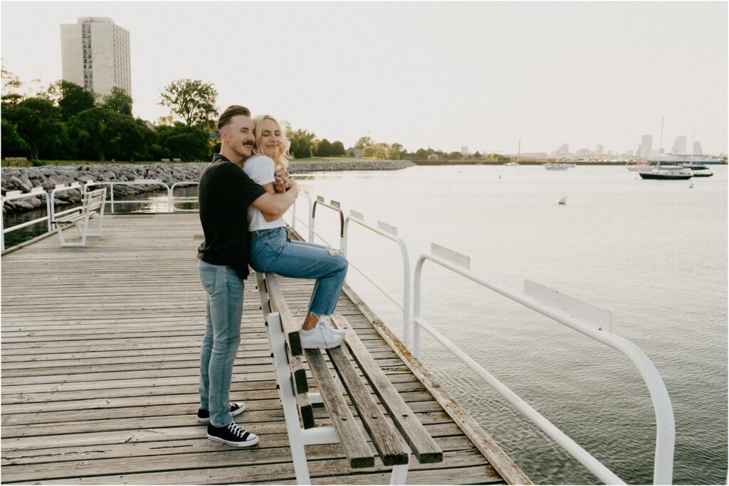 a couple sitting by the lake