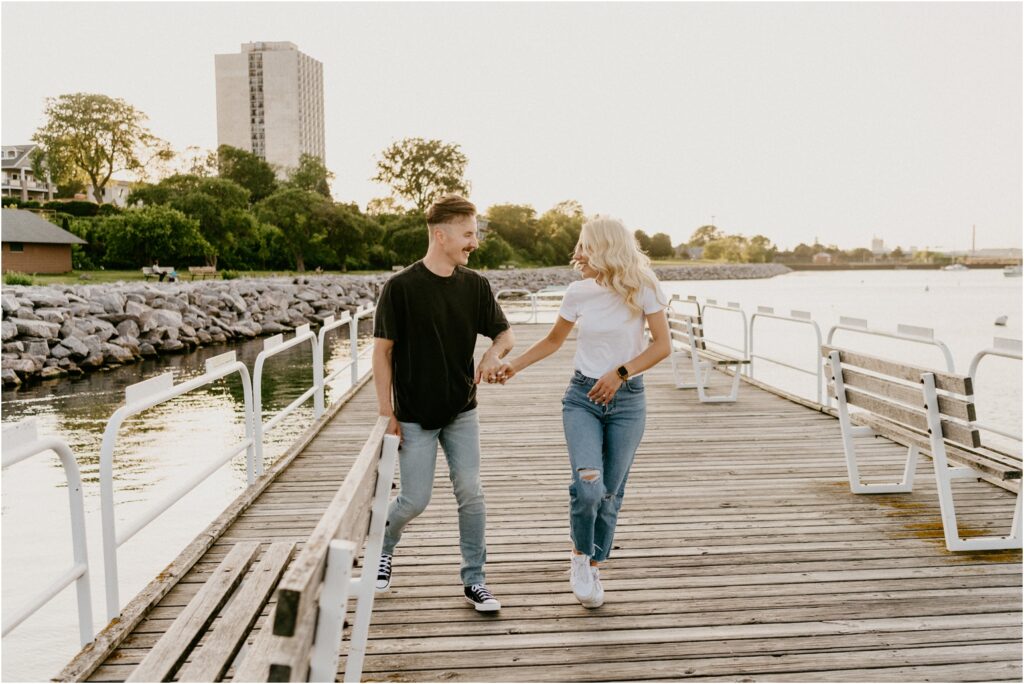 a couple running down a dock
