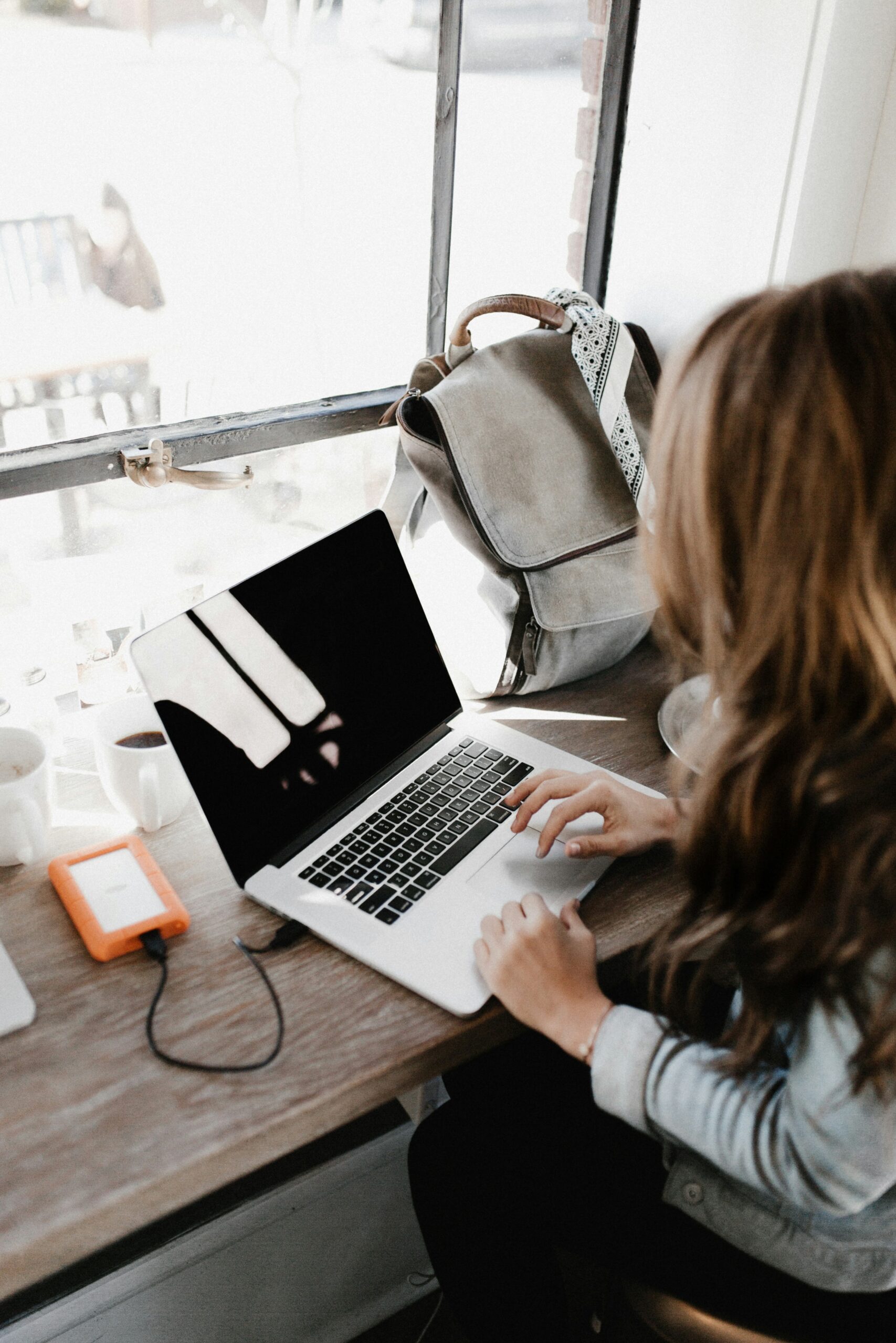 woman backing up files with lacie hard drive