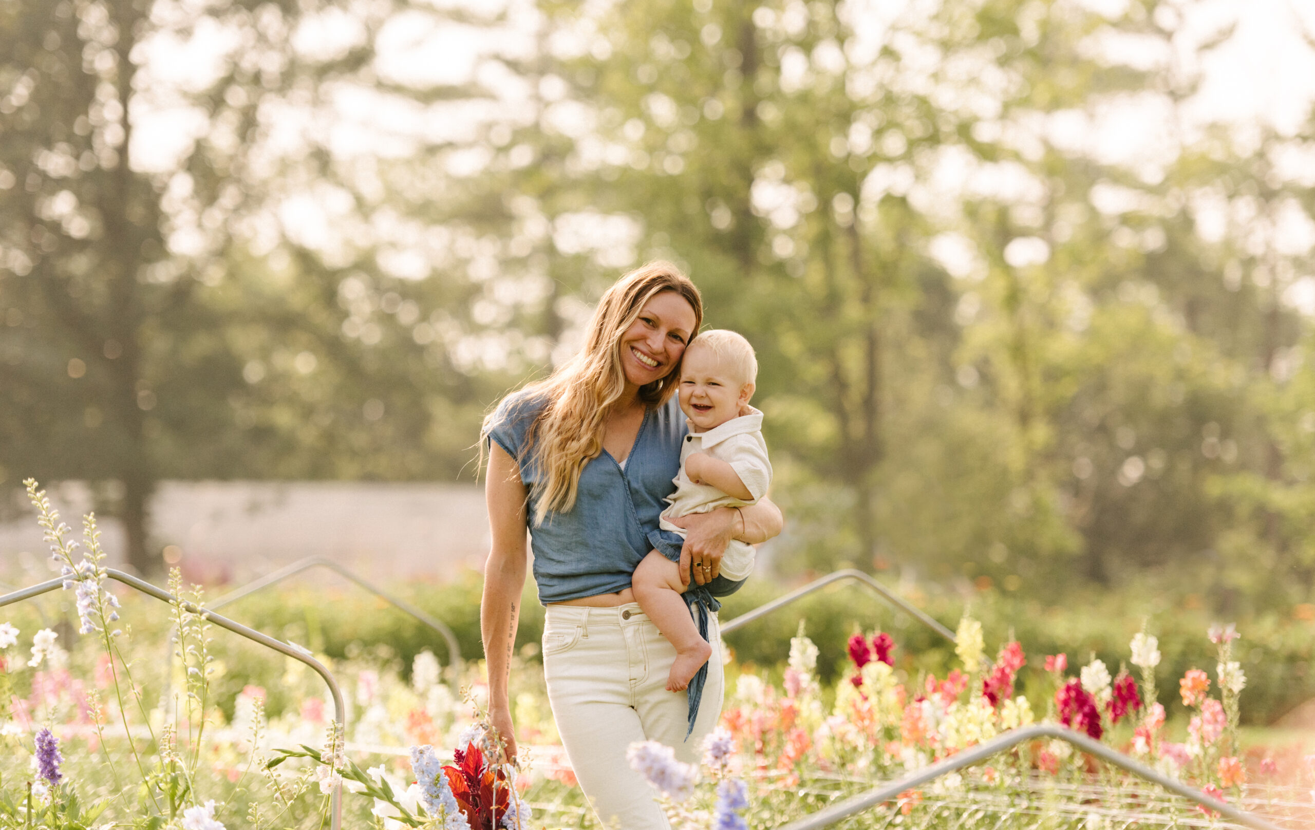 ren lenhof and her baby at flower farm in wisconsin