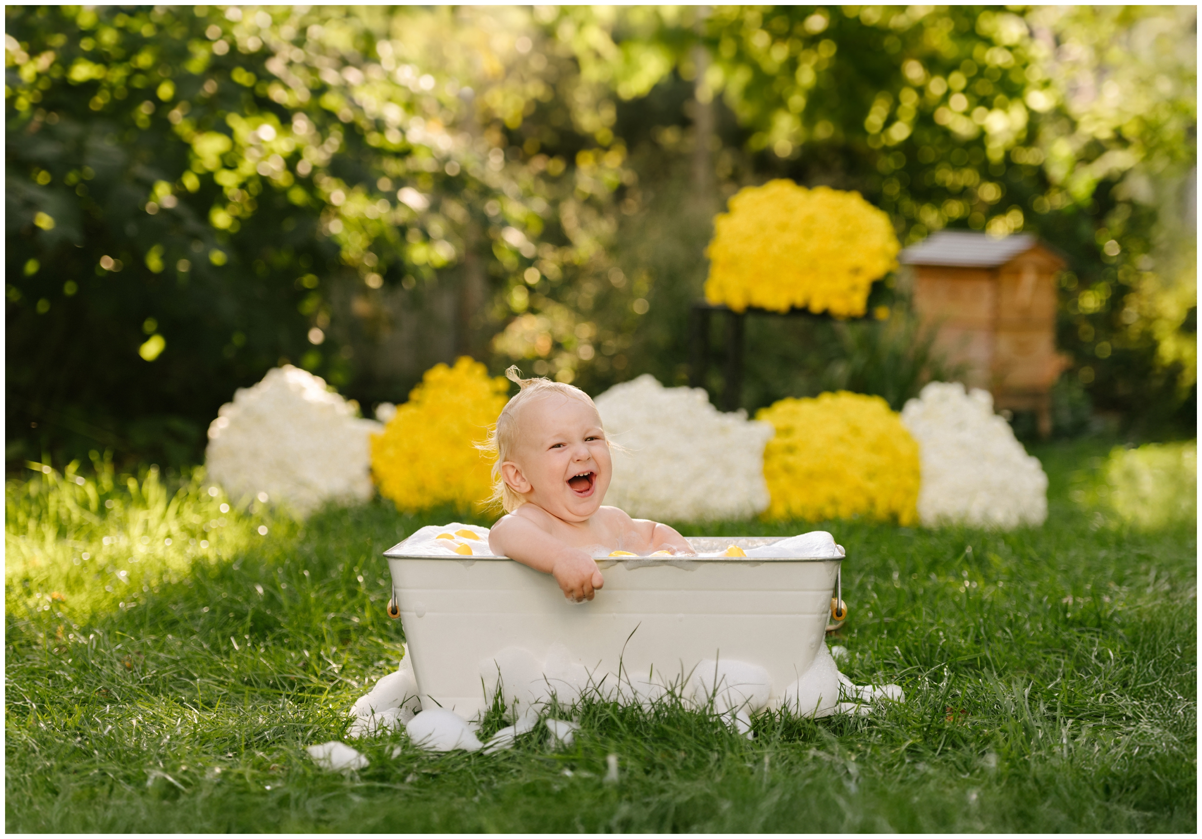 baby in bath in backyard laughing