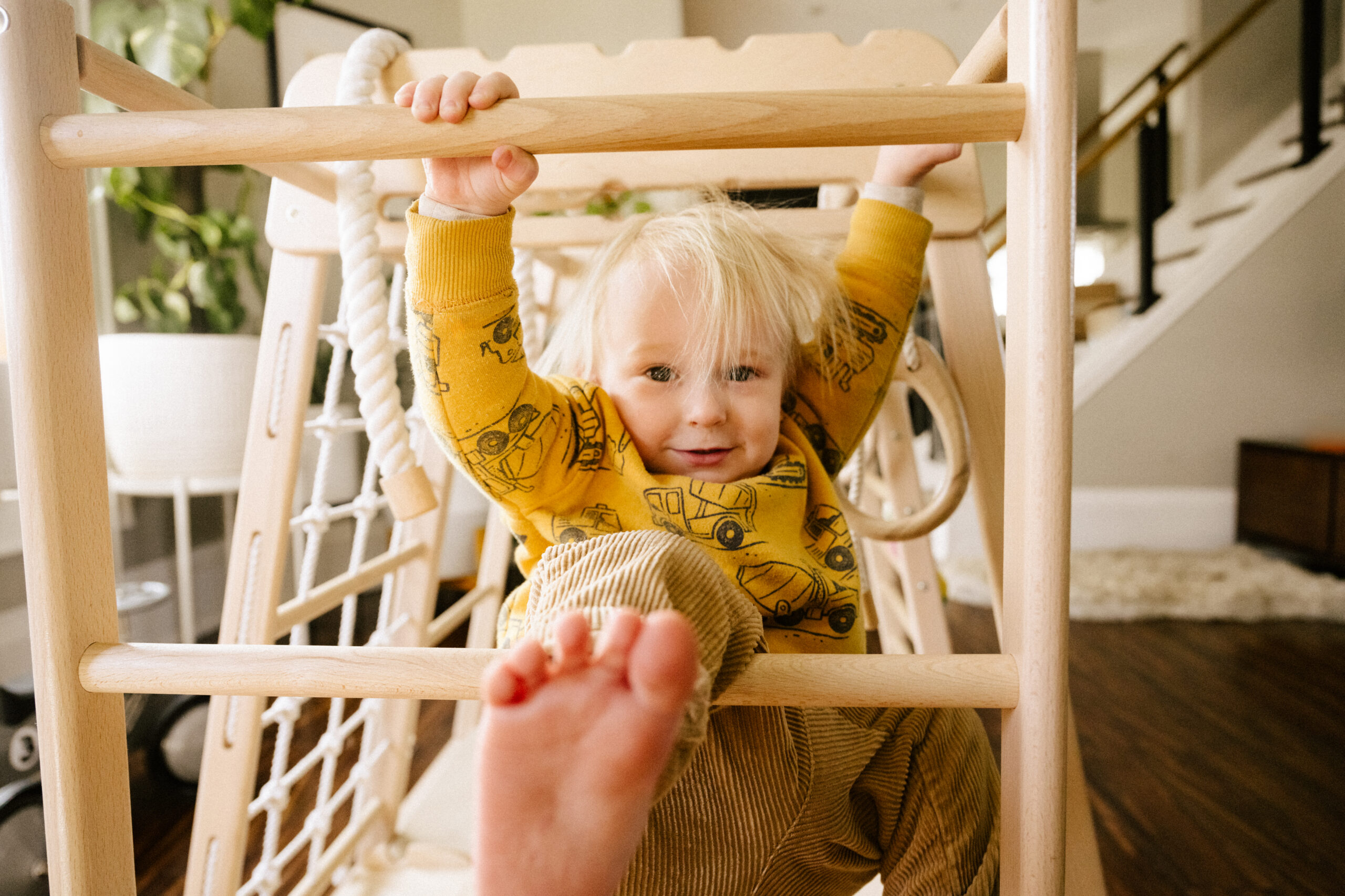 little boy on wooden jungle gym